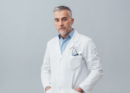 Confident doctor posing Confident doctor wearing a lab coat and posing, he is looking at camera