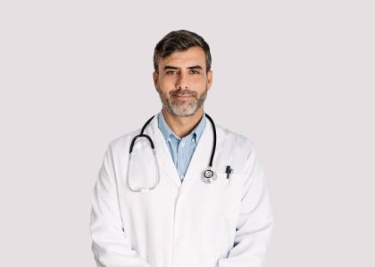 Front view of handsome doctor smiling and standing on white background Front view of handsome doctor smiling and standing on white background