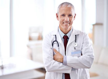 Portrait of a mature medical doctor smiling with folded arms Portrait of a mature medical doctor smiling with folded arms